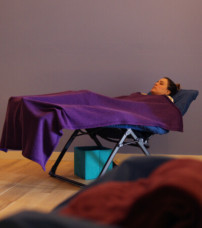 person reclining under blanket resting